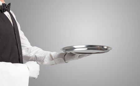 Waiter serving with white gloves and steel tray in an empty space