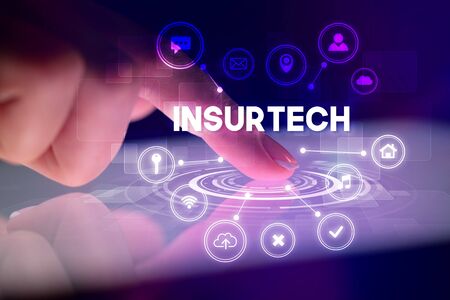 Finger touching tablet with web technology icons and INSURTECH inscription, web technology conceptの写真素材