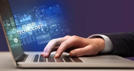 Businessman working on laptop with CLOUD TECHNOLOGY inscription, cyber technology concept