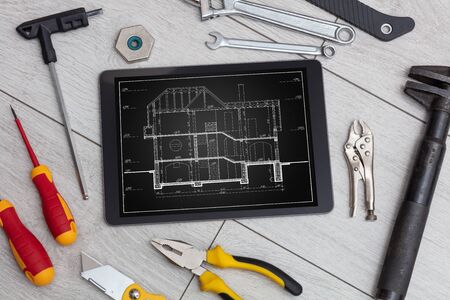 Tablet with construction tools and blueprint conceptの写真素材