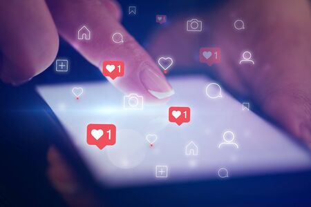 Finger touching phone with social media concept and dark backgroundの写真素材