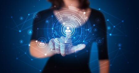 Woman touching hologram screen displaying keys and locksの写真素材