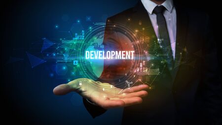 Elegant hand holding DEVELOPMENT  inscription, digital technology conceptの写真素材