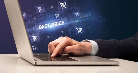 Businessman working on laptop with BEST PRICE  inscription, online shopping conceptの写真素材