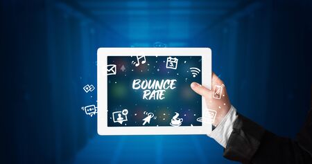 Young business person working on tablet and shows the inscription: BOUNCE RATEの写真素材
