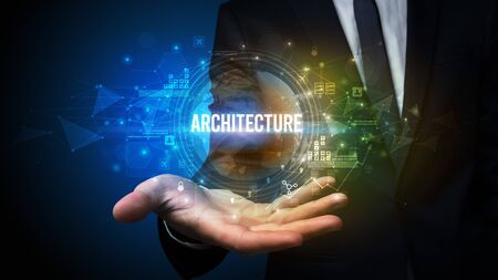 Elegant hand holding ARCHITECTURE inscription, digital technology conceptの写真素材