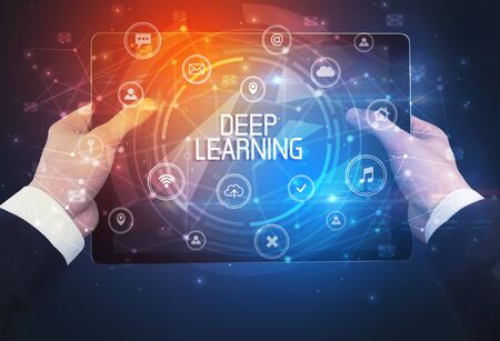 Close-up of a tablet with DEEP LEARNING inscription, innovative technology conceptの写真素材
