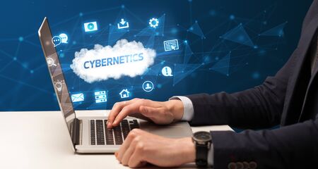 Businessman working on laptop with CYBERNETICS  inscription, modern technology conceptの写真素材