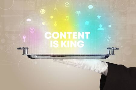 Waiter serving social networking with CONTENT IS KING inscription, new media conceptの写真素材