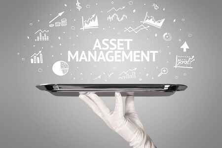 Waiter serving business idea concept with ASSET MANAGEMENT inscriptionの写真素材