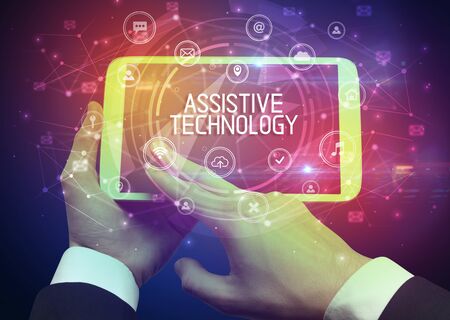 Close-up of a tablet with ASSISTIVE TECHNOLOGY inscription, innovative technology conceptの写真素材