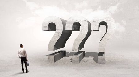 Rear view of a businessman standing in front of ??? abbreviation, attention making conceptの写真素材