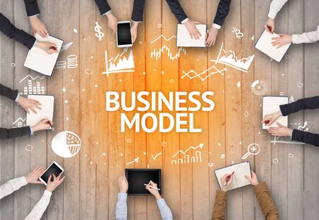Group of Busy People Working in an Office with BUSINESS MODEL inscription, succesfull business conceptの写真素材