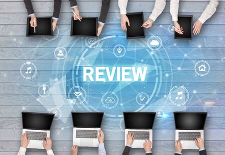 Group of people having a meeting with REVIEW insciption, social networking conceptの写真素材