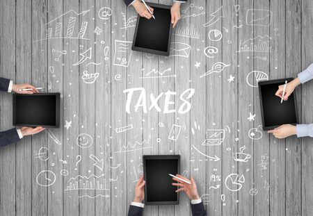 Group of business people working in office with TAXES inscription, coworking conceptの写真素材