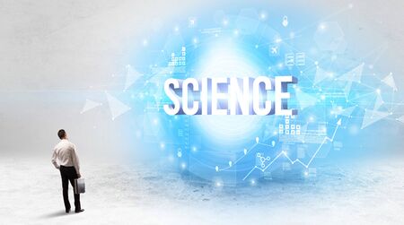 Rear view of a businessman standing in front of SCIENCE inscription, modern technology conceptの写真素材