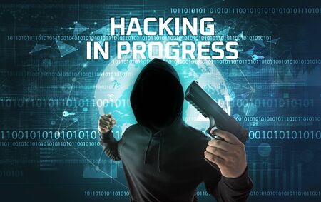 Faceless hacker at work with HACKING IN PROGRESS inscription, Computer security concept