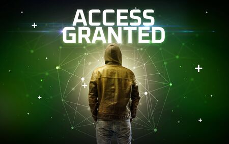 Mysterious hacker with ACCESS GRANTED inscription, online attack concept inscription, online security conceptの写真素材