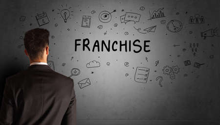 businessman drawing a creative idea sketch with FRANCHISE inscription, business strategy conceptの写真素材
