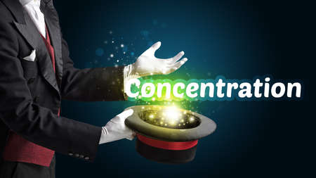 Magician is showing magic trick with Concentration inscription, educational conceptの写真素材