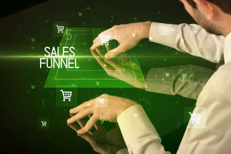 Online shopping with SALES FUNNEL inscription concept, with shopping cart iconsの写真素材