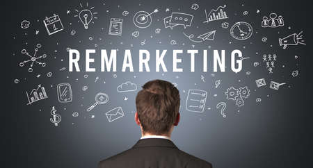 Rear view of a businessman with REMARKETING inscription, modern business conceptの写真素材