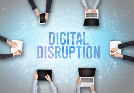 Group of people in front of a laptop with DIGITAL DISRUPTION insciption, web security conceptの写真素材