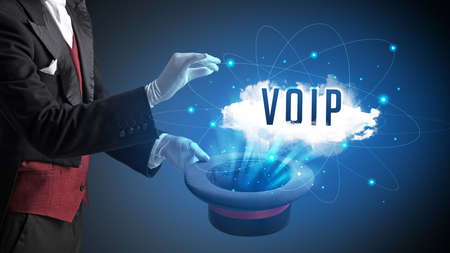 Magician is showing magic trick with VOIP abbreviation, modern tech conceptの写真素材