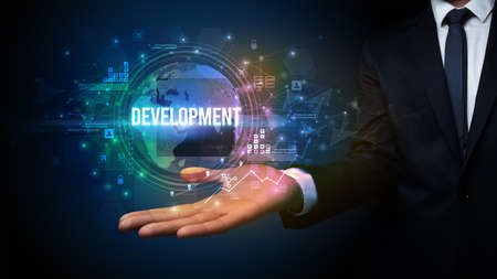 Elegant hand holding DEVELOPMENT inscription, digital technology conceptの写真素材