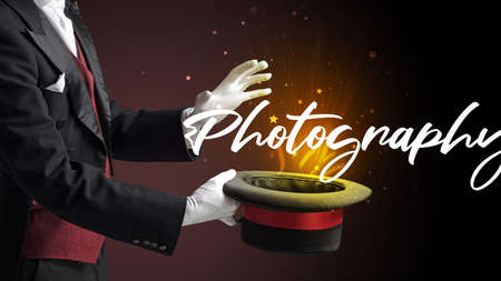 Magician is showing magic trick with Photography inscription, traveling conceptの写真素材