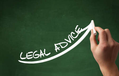 Hand drawing LEGAL ADVICE inscription with white chalk on blackboard, business conceptの写真素材