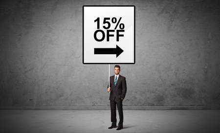 business person holding a traffic sign with 15% OFF inscription, new idea conceptの写真素材