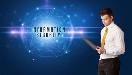 Businessman thinking about security solutions with INFORMATION SECURITY inscriptionの写真素材