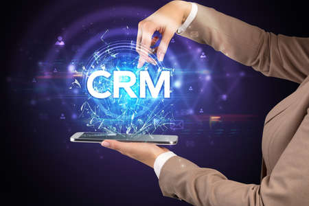 Close-up of a touchscreen with CRM abbreviation, modern technology conceptの写真素材