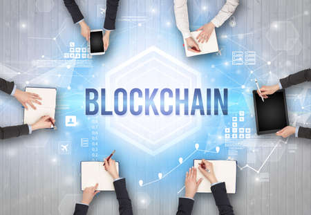 Group of Busy People Working in an Office with BLOCKCHAIN inscription, modern technology concept