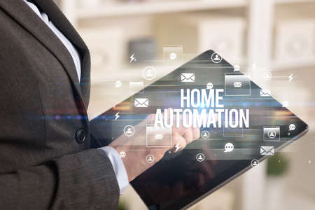 Close-up of a tablet searching HOME AUTOMATION inscription, modern technology conceptの写真素材