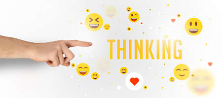 Close-Up of cropped hand pointing at THINKING inscription, social media conceptの写真素材