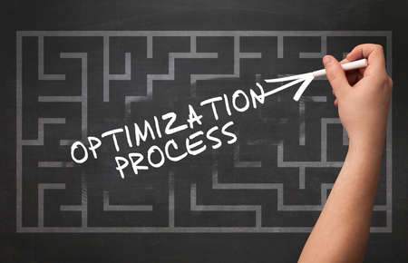Hand drawing OPTIMIZATION PROCESS inscription with white chalk on blackboard, new business concept