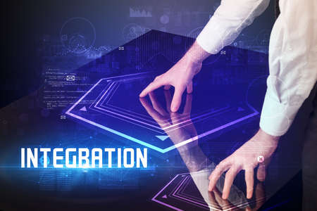 Hand touching digital table with INTEGRATION inscription, new age security conceptの写真素材