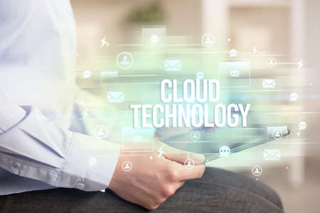 Close-up of a tablet searching CLOUD TECHNOLOGY inscription, modern technology concept