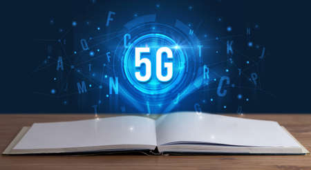 5G inscription coming out from an open book, digital technology conceptの写真素材