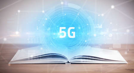 Open book with 5G abbreviation, modern technology conceptの写真素材