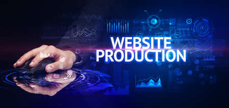 hand holding wireless peripheral with WEBSITE PRODUCTION inscription, modern technology concept