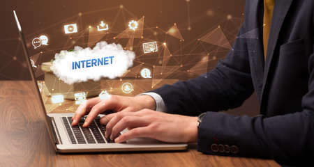 Businessman working on laptop with INTERNET inscription, modern technology conceptの写真素材