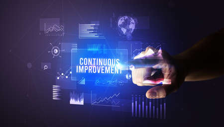 Hand touching CONTINUOUS IMPROVEMENT inscription, new business technology conceptの写真素材