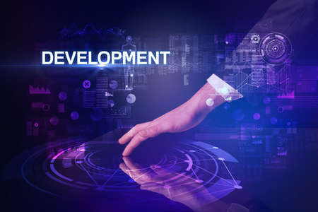 Businessman touching huge display with DEVELOPMENT inscription, modern technology conceptの写真素材