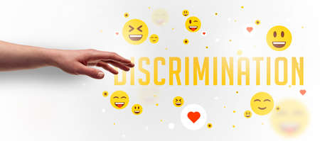Close-Up of cropped hand pointing at DISCRIMINATION inscription, social media concept