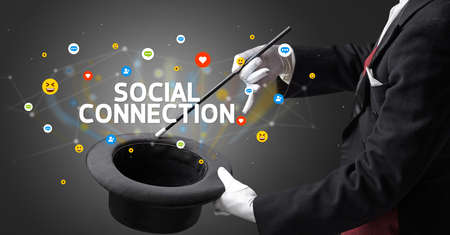 Magician is showing magic trick with SOCIAL CONNECTION inscription, social media marketing conceptの写真素材