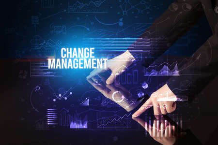 Businessman touching huge screen with CHANGE MANAGEMENT inscription, cyber business conceptの写真素材