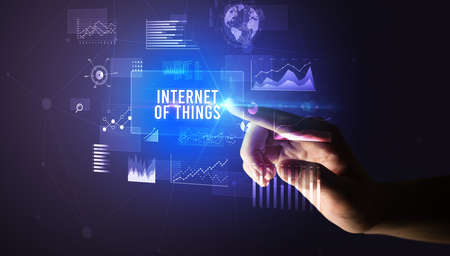 Hand touching INTERNET OF THINGS inscription, new business technology conceptの写真素材